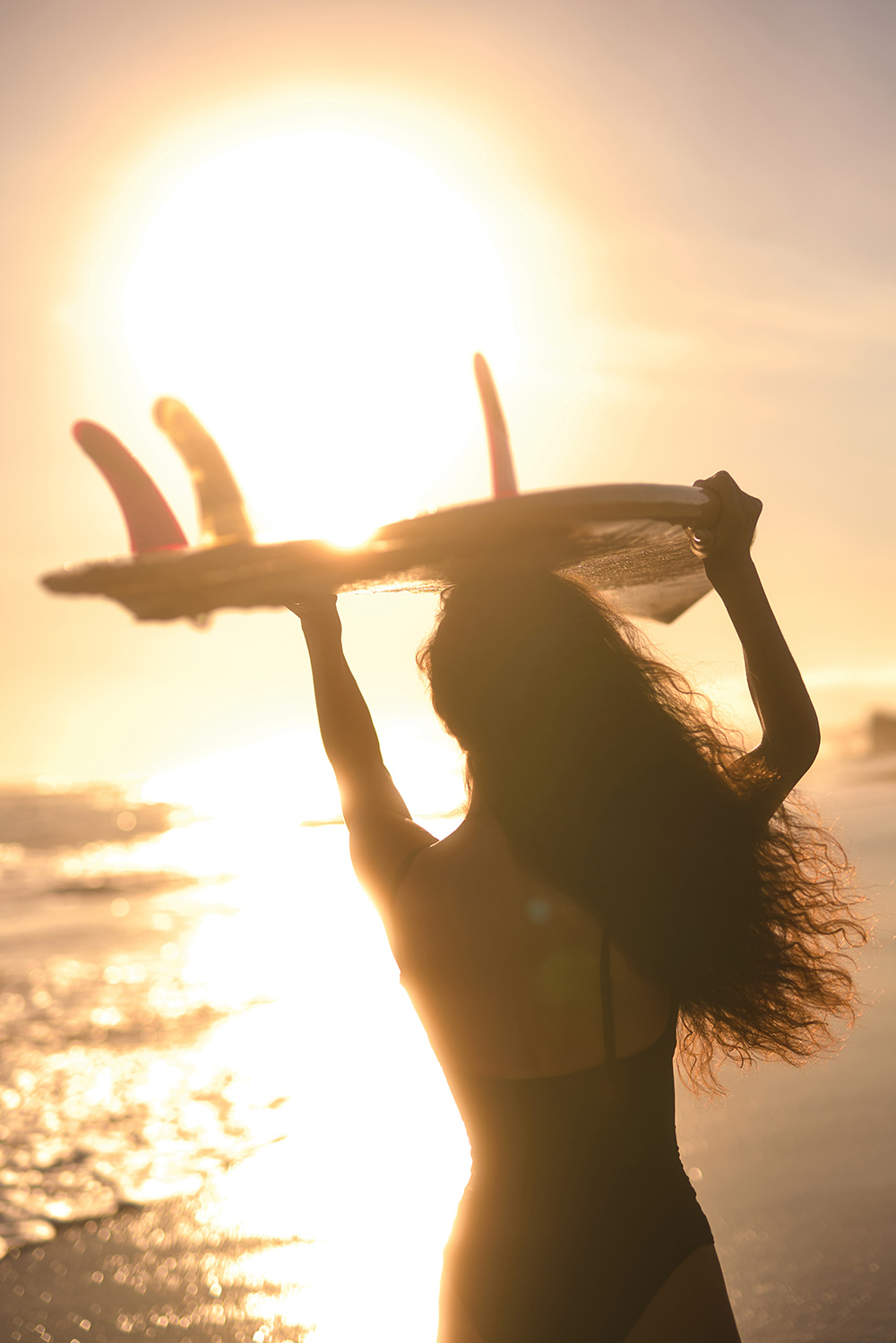 A woman laughing during a seaside workout